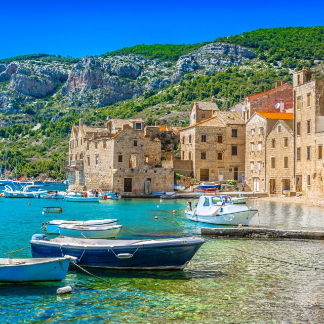 Seafront scenic view at Komiza summer scenery in South of Croatia, mediterranean travel places.